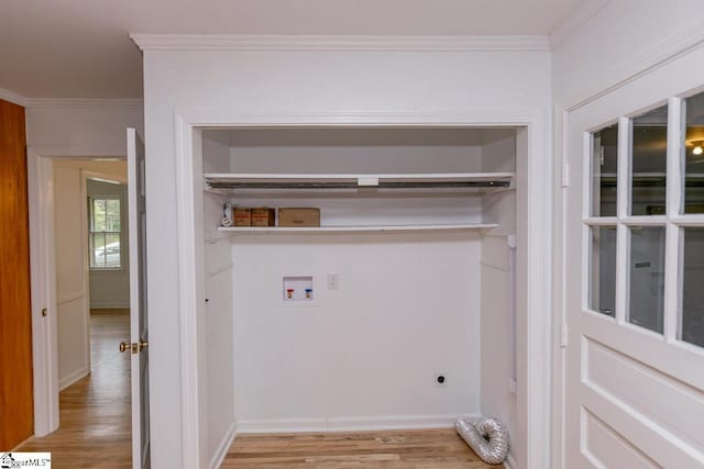 laundry area featuring hookup for a washing machine, ornamental molding, electric dryer hookup, and light wood-type flooring