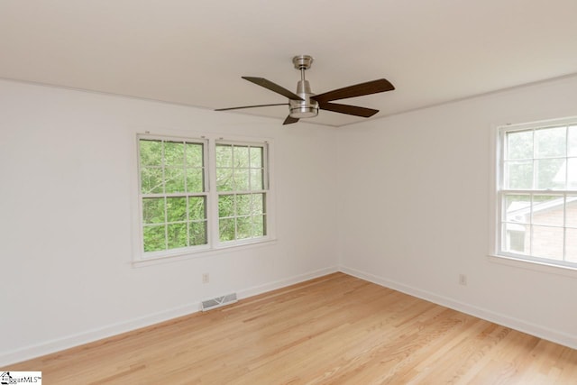 unfurnished room featuring ceiling fan, ornamental molding, and light hardwood / wood-style floors