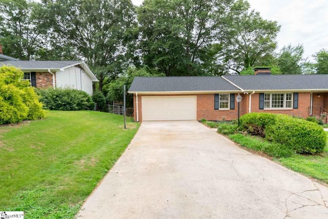 view of front of home featuring a garage and a front lawn