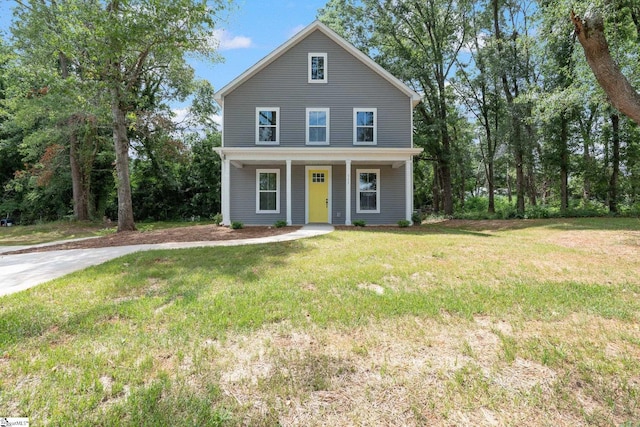 traditional-style home with covered porch and a front yard