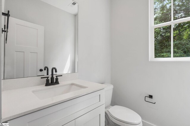 bathroom with toilet and vanity