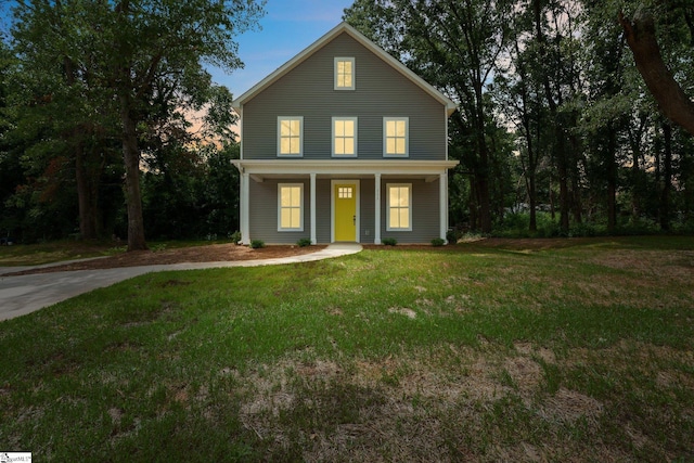 view of front property with covered porch and a yard