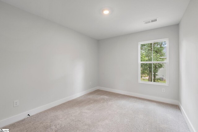 spare room with light carpet