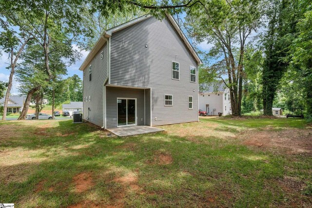 back of house with a patio area, a lawn, and cooling unit