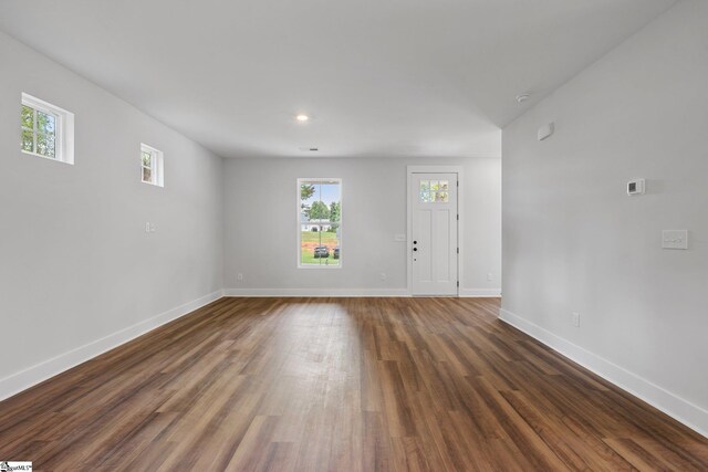 unfurnished living room featuring dark hardwood / wood-style floors