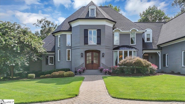 view of front of property featuring a front yard and french doors