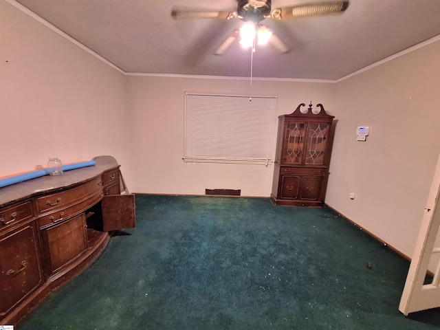 interior space featuring ornamental molding, dark colored carpet, and ceiling fan