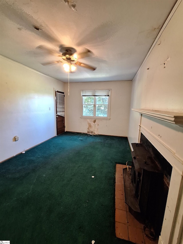 unfurnished living room featuring carpet flooring, a fireplace, and ceiling fan