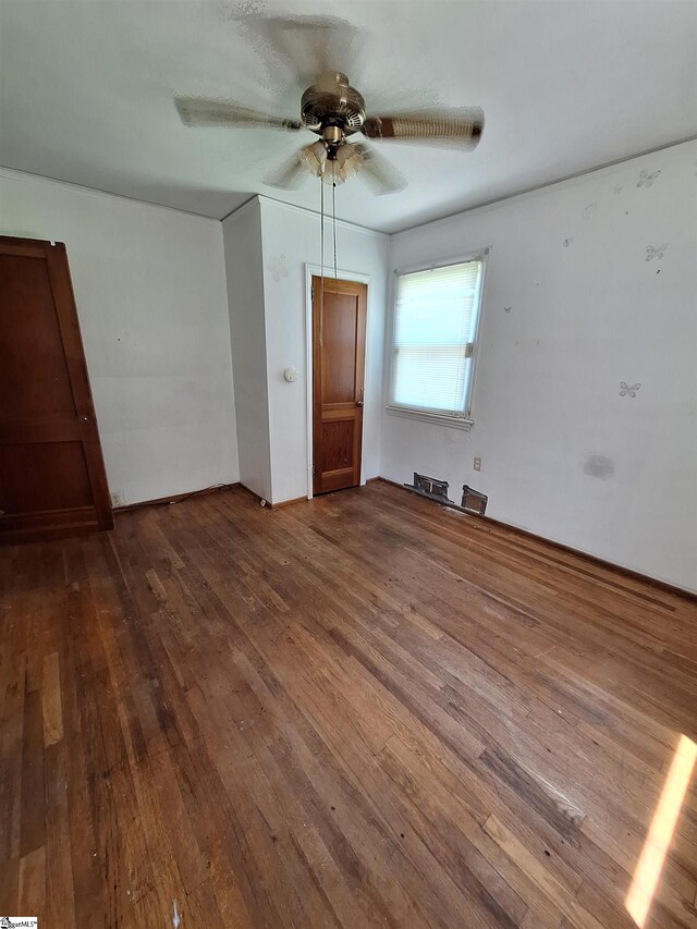 empty room featuring ceiling fan and wood-type flooring