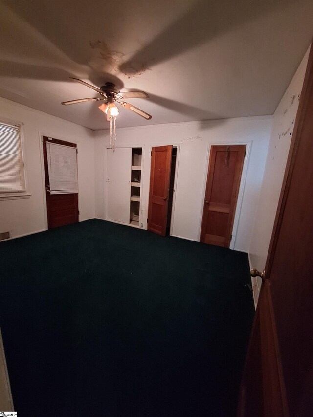 unfurnished bedroom featuring ceiling fan