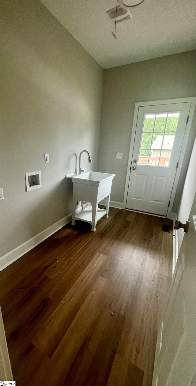 interior space with hookup for a washing machine and wood-type flooring