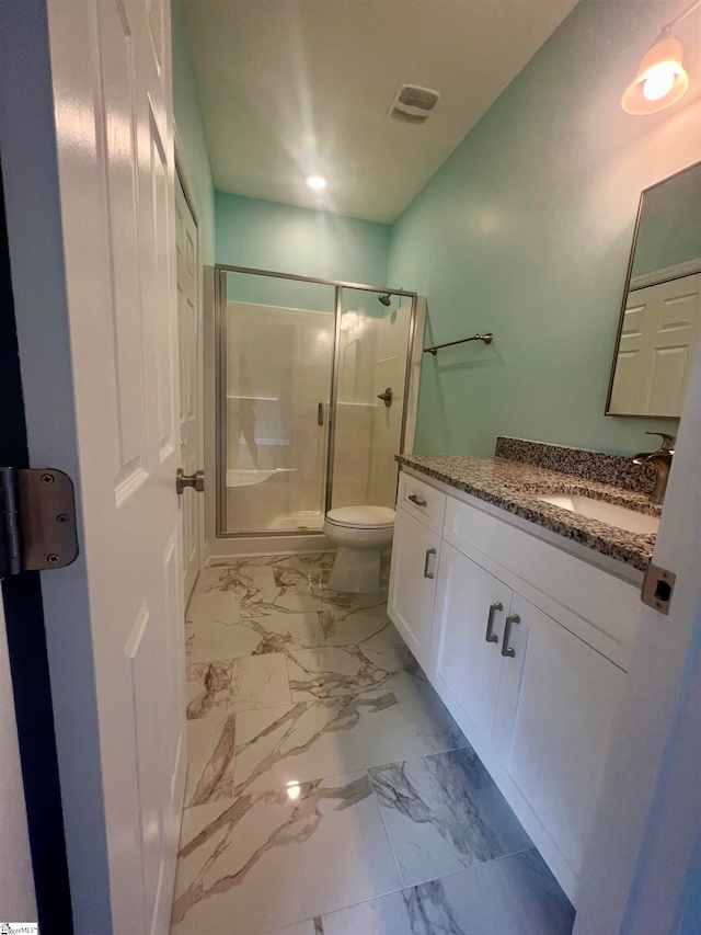 bathroom featuring vanity, walk in shower, toilet, and tile patterned floors