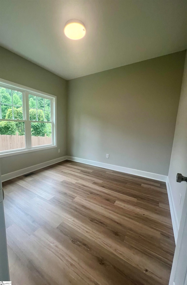 unfurnished room featuring wood-type flooring