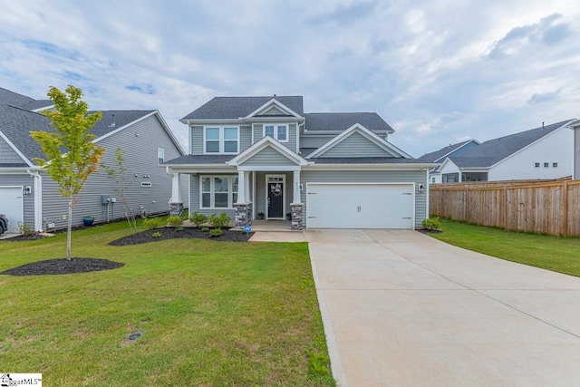 craftsman-style home featuring fence, driveway, and a front lawn