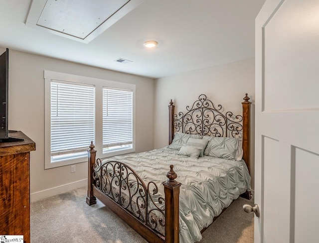 bedroom featuring baseboards, attic access, visible vents, and carpet flooring