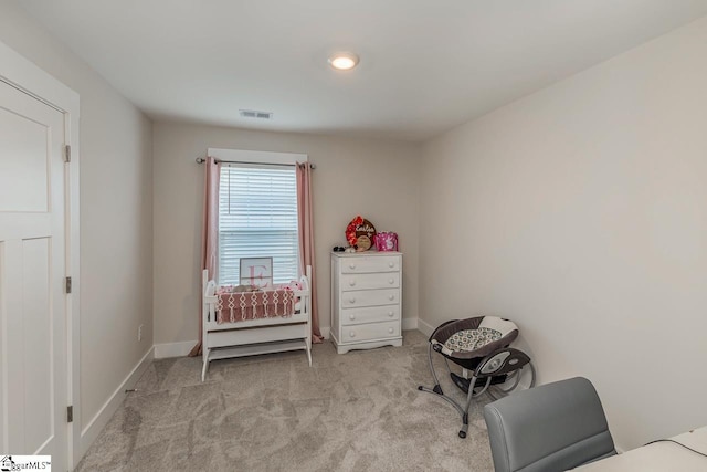 interior space with light carpet, visible vents, and baseboards