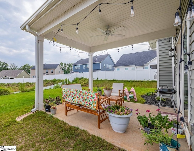 view of patio / terrace with a residential view, fence, and a ceiling fan