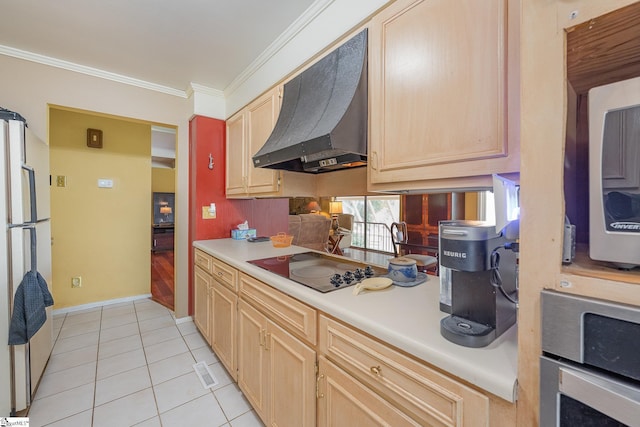 kitchen featuring black electric stovetop, light countertops, custom exhaust hood, freestanding refrigerator, and light brown cabinetry