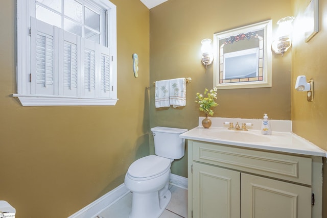 bathroom with baseboards, vanity, toilet, and tile patterned floors