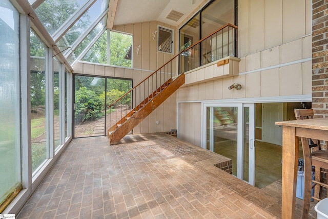 sunroom featuring vaulted ceiling with skylight