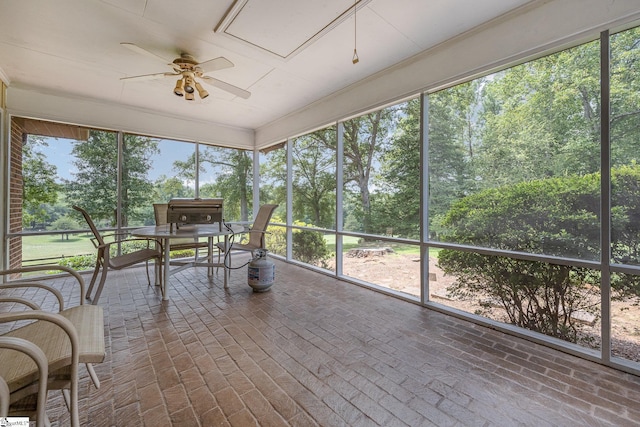 unfurnished sunroom with ceiling fan