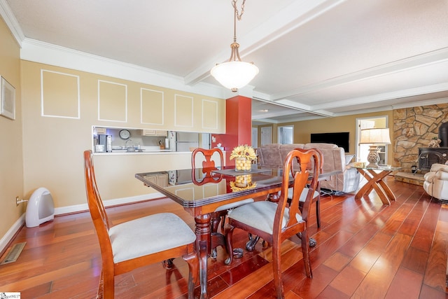 dining area featuring beamed ceiling, wood finished floors, visible vents, and baseboards