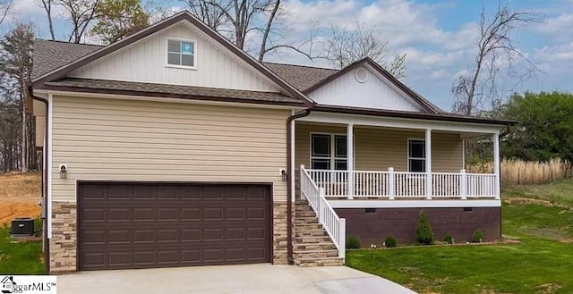 view of front of home with cooling unit, a porch, and a garage