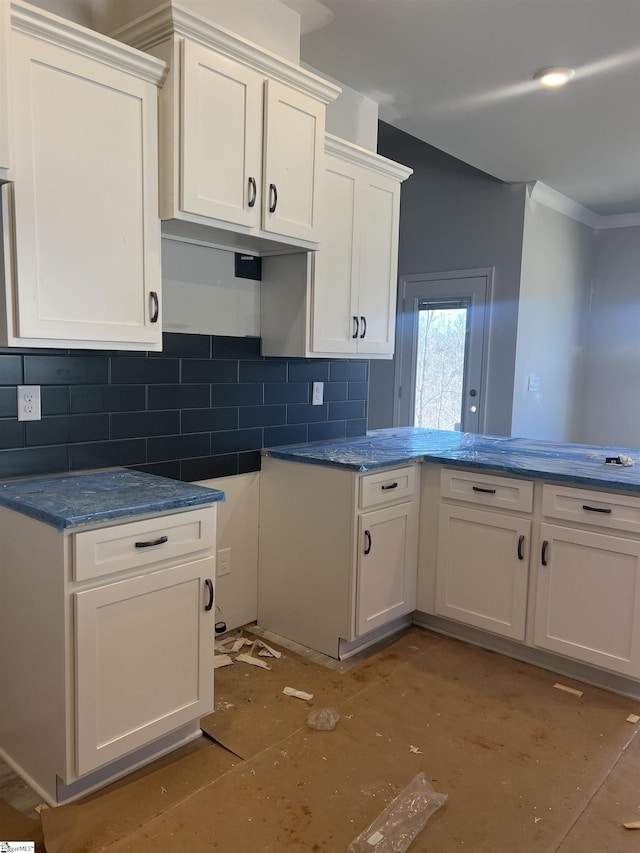 kitchen with white cabinets and decorative backsplash