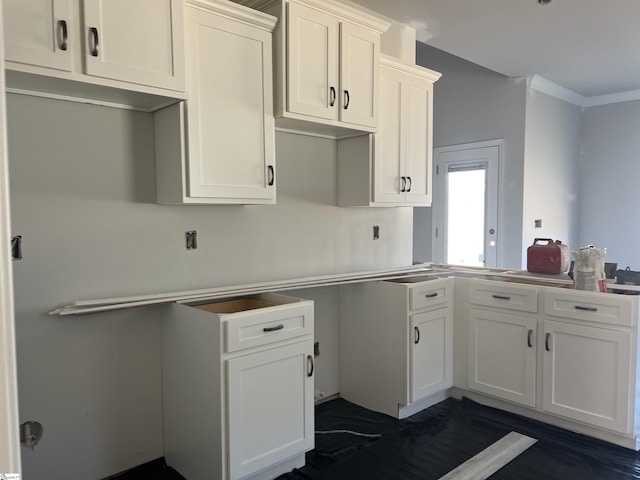 kitchen with crown molding and white cabinets