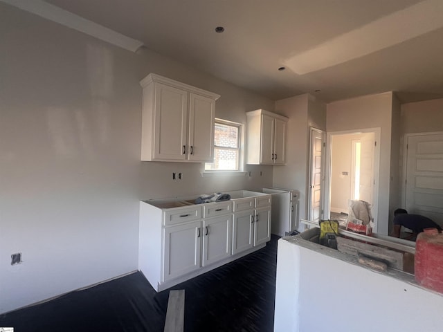 kitchen with dark wood-style floors and white cabinets