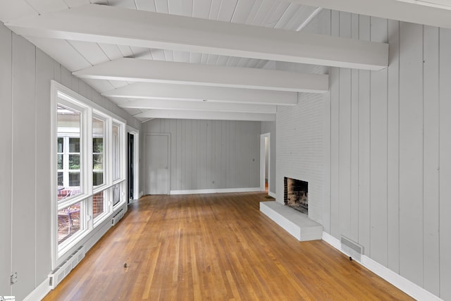 unfurnished living room featuring baseboards, a fireplace, visible vents, and hardwood / wood-style floors