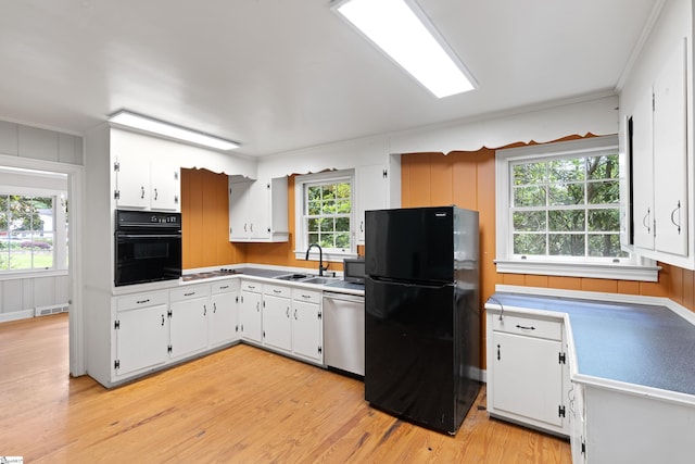 kitchen with black appliances, a sink, visible vents, and white cabinets