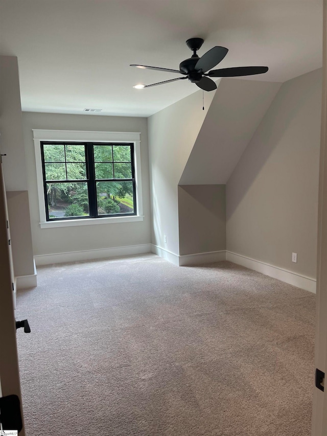 bonus room featuring lofted ceiling, light colored carpet, and ceiling fan