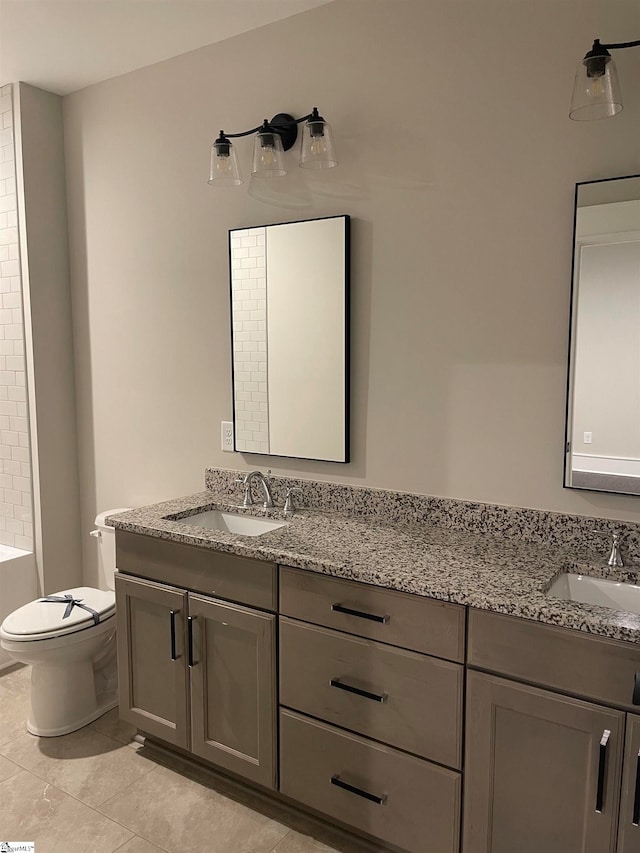 bathroom with tile patterned floors, vanity, and toilet