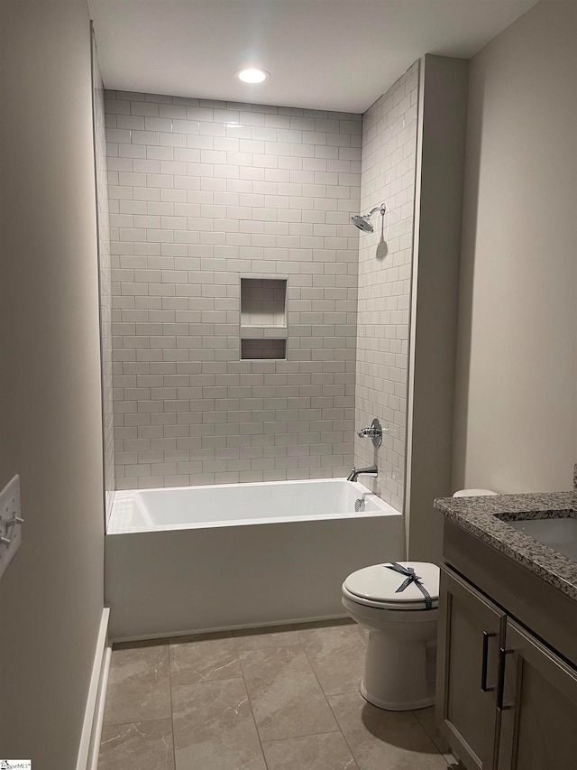 full bathroom featuring vanity, tiled shower / bath combo, and toilet