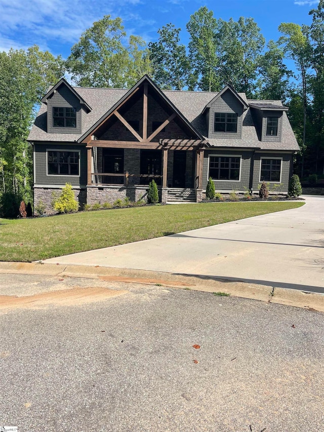 craftsman-style home featuring a porch and a front lawn