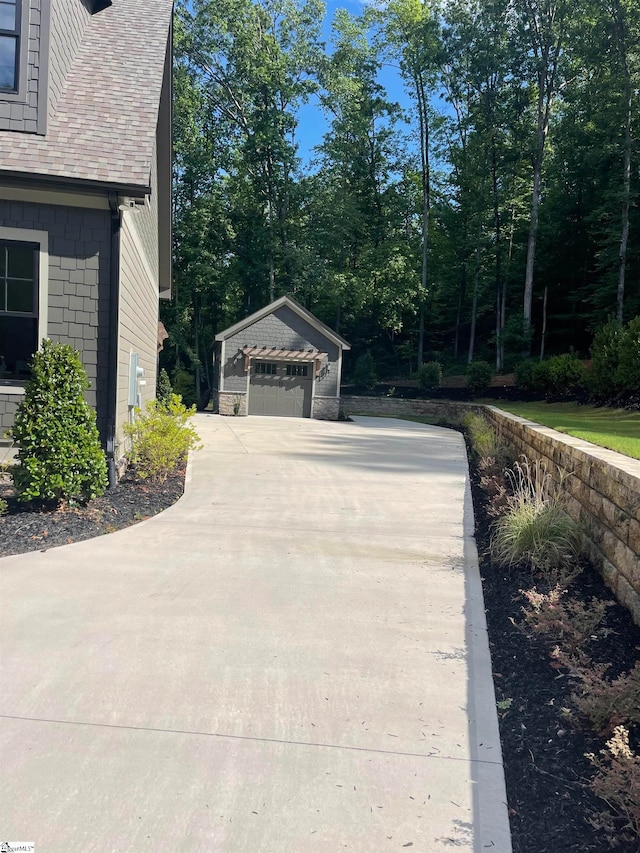 view of property exterior with an outbuilding and a garage