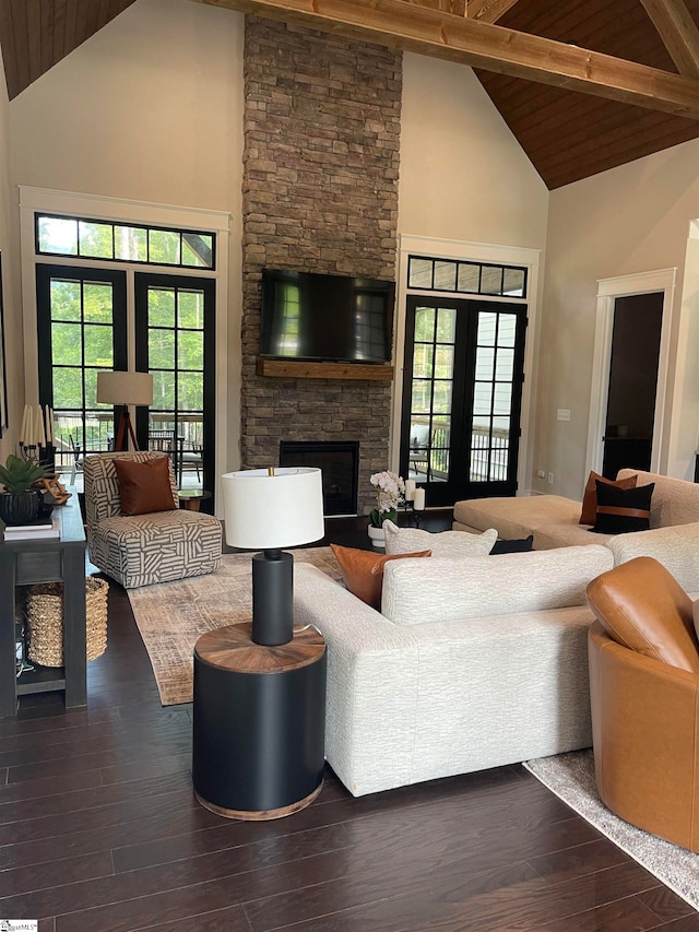 living room featuring a stone fireplace, high vaulted ceiling, french doors, and hardwood / wood-style flooring