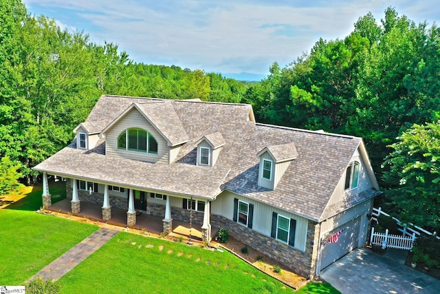 302 Meadowlark Ln, Seneca, SC 29672 - cape cod house with a porch, stone siding, fence, a front lawn, and driveway