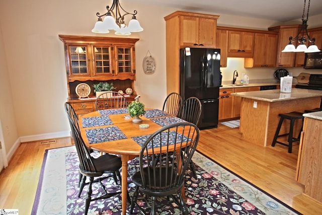 302 Meadowlark Ln, Seneca, SC 29672 - dining space with a chandelier, light wood finished floors, visible vents, and baseboards