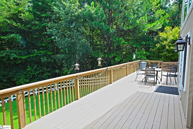 wooden terrace featuring a yard