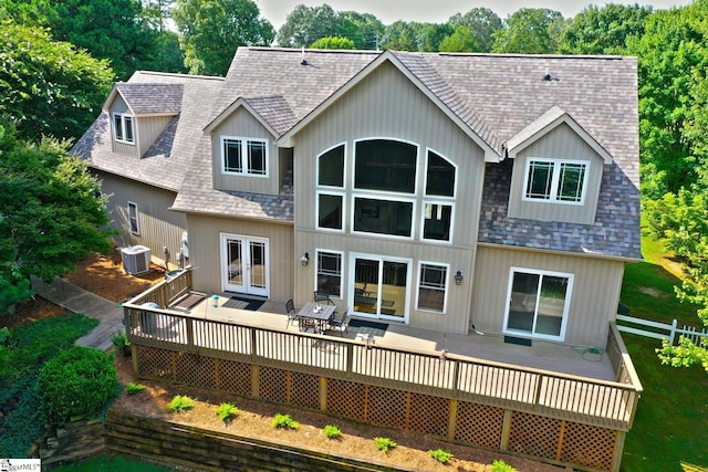 rear view of property featuring a wooden deck, french doors, and cooling unit