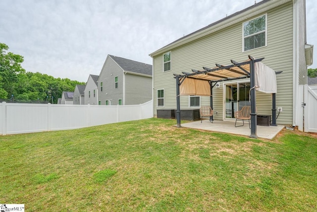 rear view of house featuring a pergola, a patio area, and a lawn