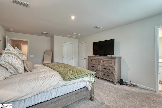 carpeted bedroom featuring ensuite bathroom