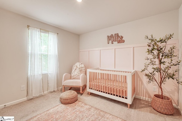 carpeted bedroom with a crib