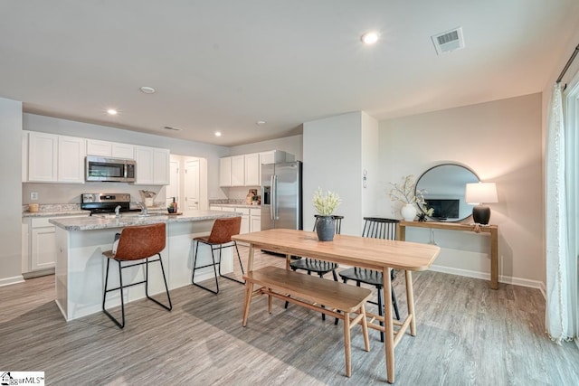 dining room featuring light hardwood / wood-style floors