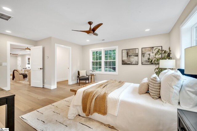 bedroom featuring light wood-type flooring and ceiling fan