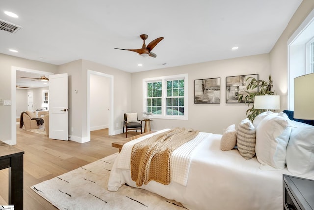 bedroom with ceiling fan and light hardwood / wood-style floors