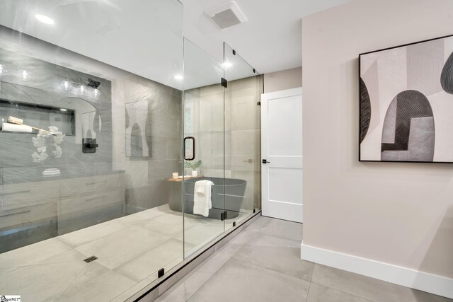 bathroom with a shower with shower door and tile patterned flooring