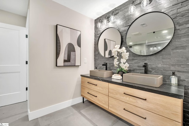 bathroom with tasteful backsplash, tile patterned floors, and vanity